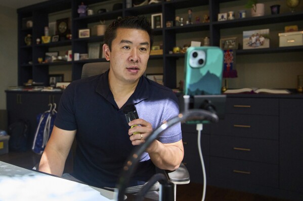 Jim Wang, a software engineer and finance blogger, records a video in his home office, Thursday, July 24, 2025, in Fulton.