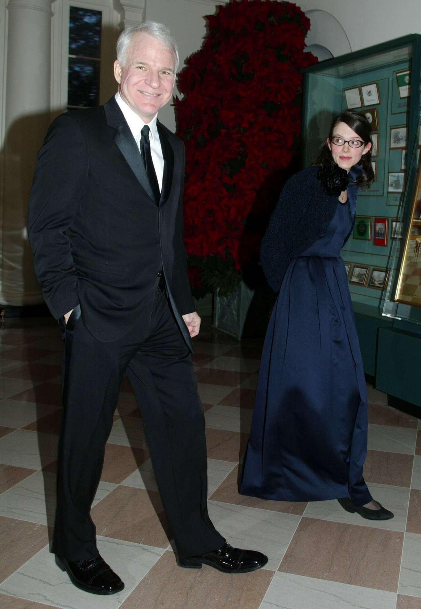 Steve Martin (L) arrives for a reception of the 2002 Kennedy Center Honors with his guest Anne Stringfield December 8, 2002 at the White House in Washington, D.C. The Kennedy Center selected five individuals, including actor James Earl Jones, conductor James Levine, musical theater actress Chita Rivera, singer Paul Simon and actress Elizabeth Taylor, to be the recipients of the 2002 Kennedy Center Honors for their contributions to the cultural life of the nation,
