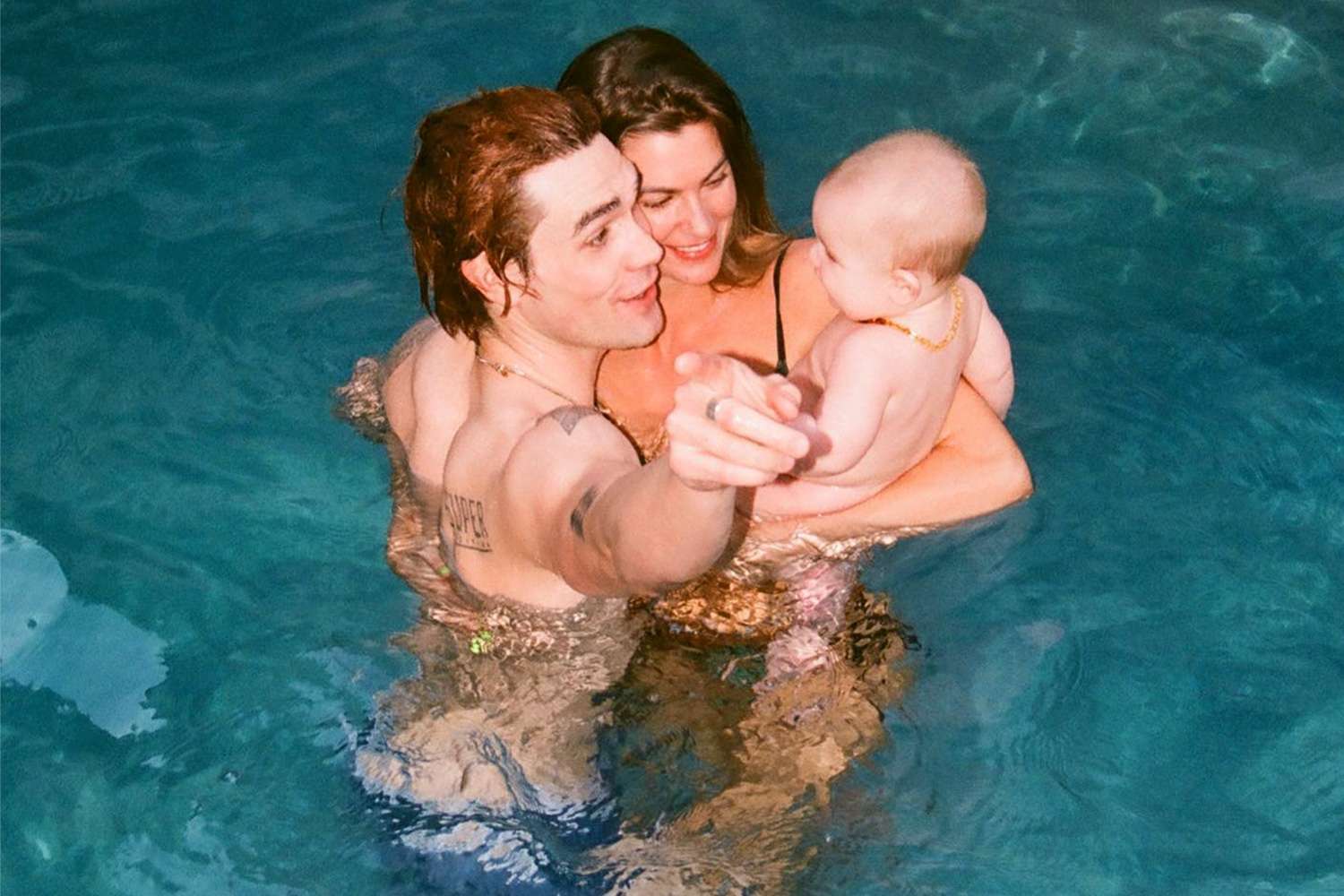KJ Apa, Clara Berry and baby in the pool