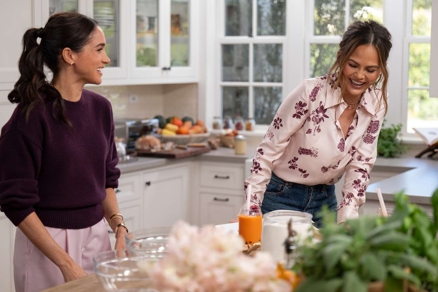Meghan Duchess of Sussex and Chrissy Teigen in a kitchen setting