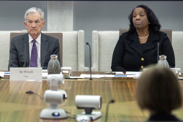 Federal Reserve Chairman Jerome Powell, and Board of Governors member Lisa Cook, right, listen during an open meeting of the Board of Governors at the Federal Reserve, June 25, 2025, in Washington.