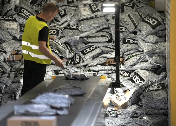 A staff member unloads a container at the DHL Mega Parcel Center in Ludwigsfelde near Berlin, Germany, May 31, 2022.