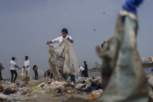 Volunteers clean up plastic and other waste on a beach in Mumbai