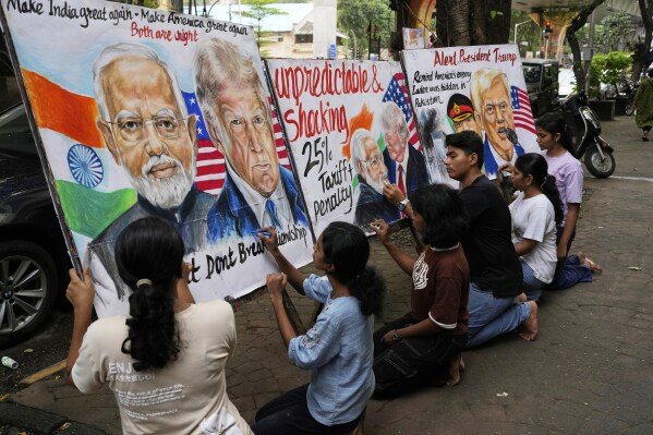 Students of Gurukul school of Art work on paintings of Donald Trump and Narendra Modi in Mumbai