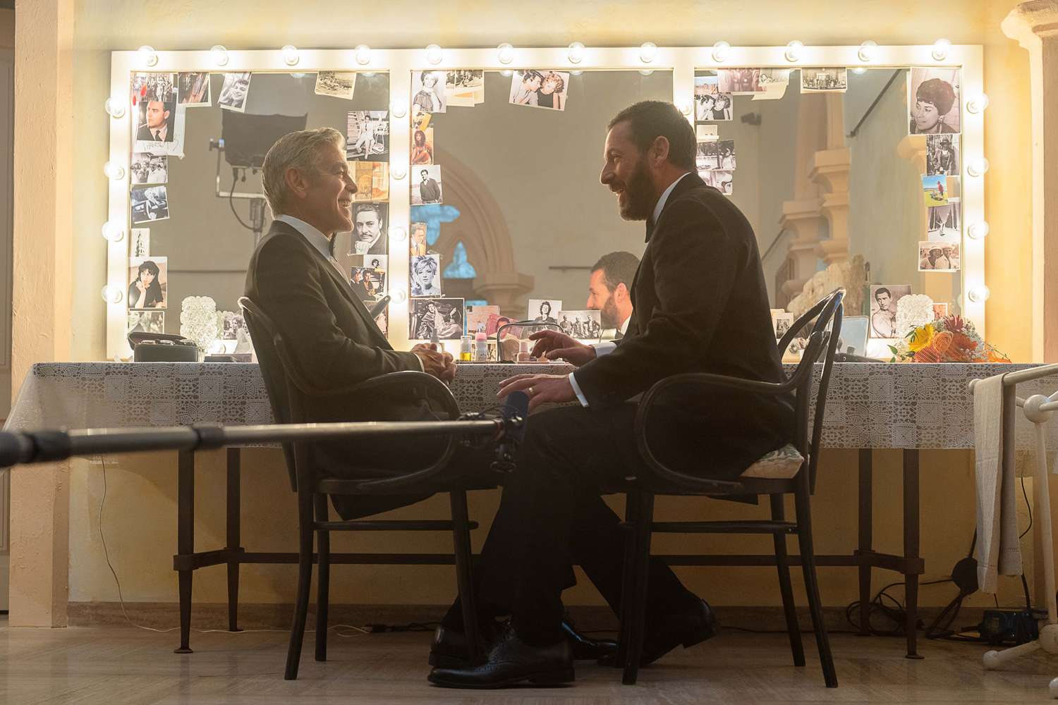 George Clooney as Jay Kelly and Adam Sandler as Ron Sukenick on the set of Jay Kelly.