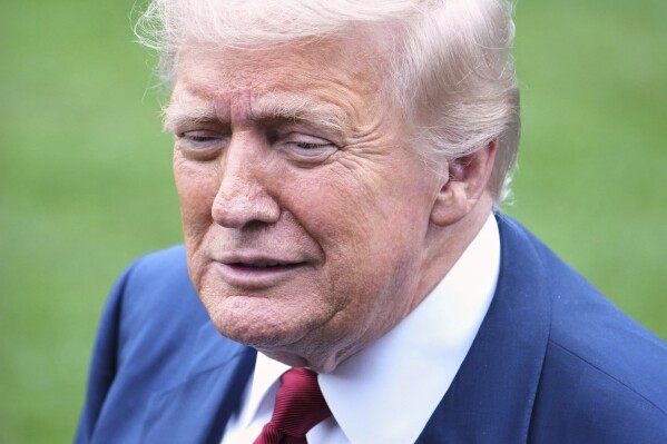 President Donald Trump speaks with reporters at the White House.