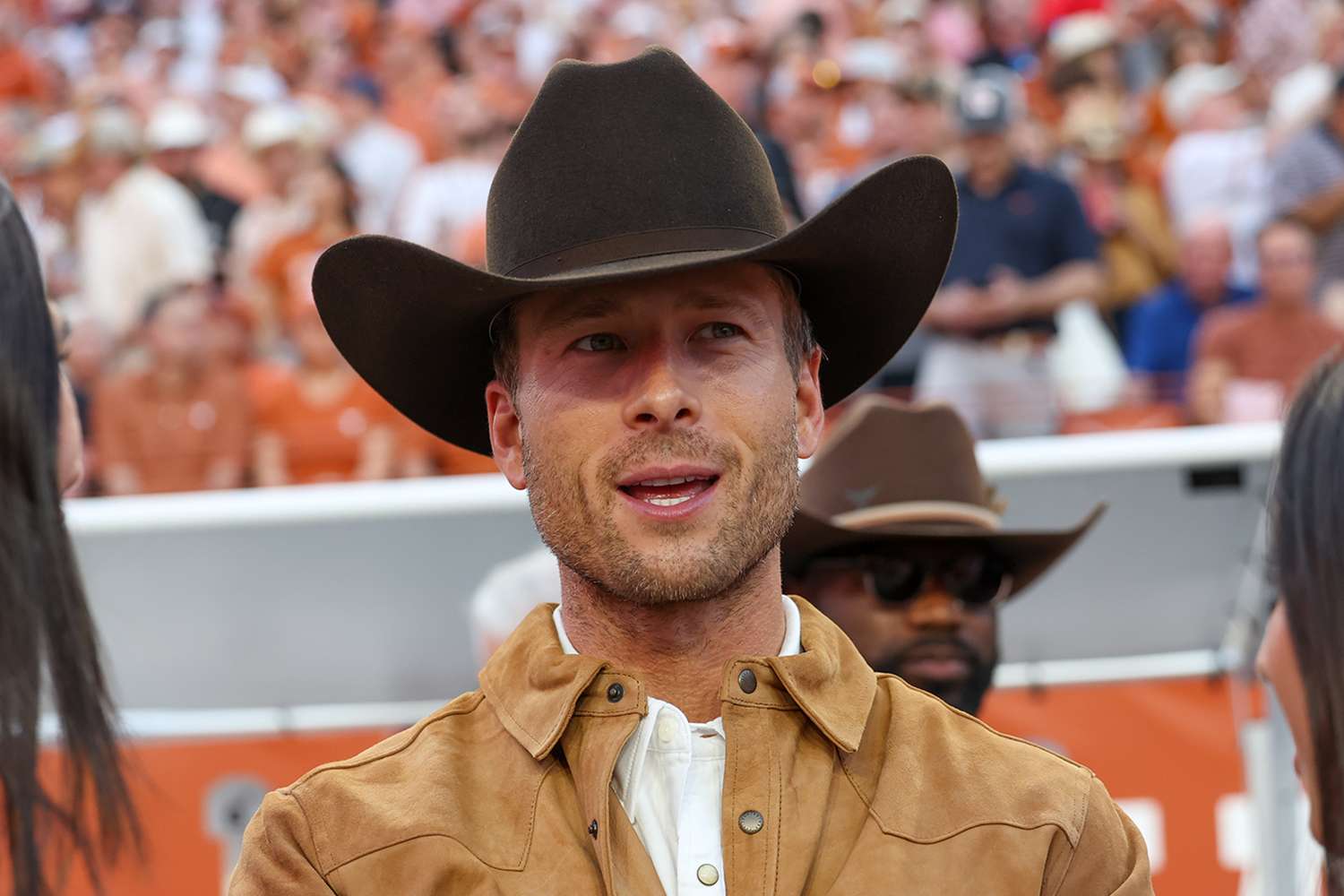 Glen Powell on the field before the SEC college football game between Texas Longhorns and Georgia Bulldogs on October 19, 2024, at Darrell K Royal - Texas Memorial Stadium in Austin, TX.