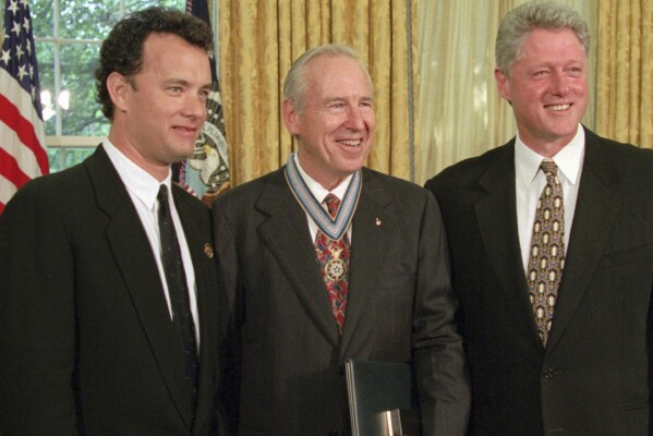 President Clinton stands with actor Tom Hanks, left, and former astronaut James Lovell in the Oval Office of the White House Wednesday, July 26, 1995, after presenting Lovell with the Congressional Space Medal of Honor. Hanks portrayed Lovell in the movie "Apollo 13."
