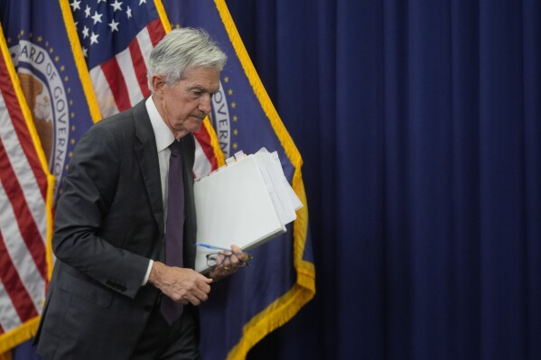 Federal Reserve Chairman Jerome Powell walks off after a news conference