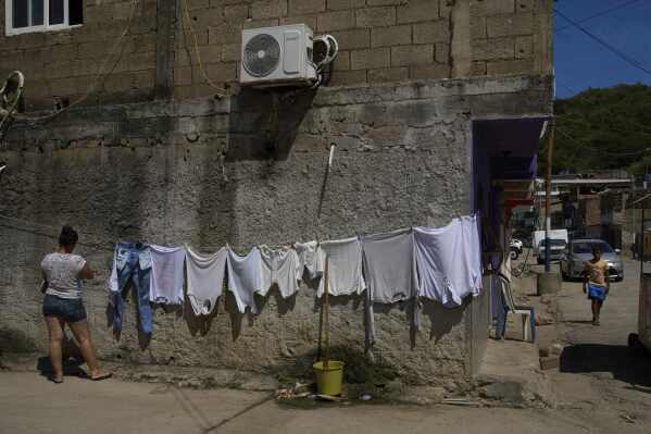 A woman hangs clothes to dry in the fishing community of El Morro de Puerto Santo, on Venezuela