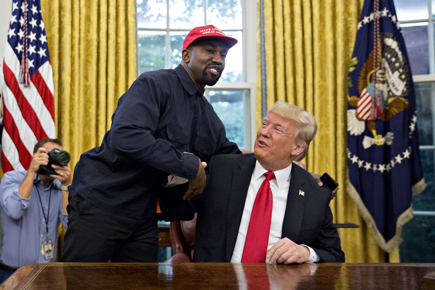 Kanye West shakes hands with U.S. President Donald Trump