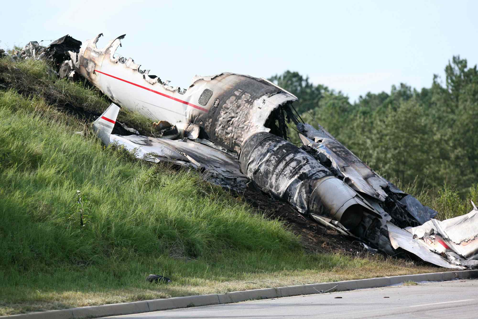 Officials wait to investigate a private jet crash carrying six people near the Columbia Airport in West Columbia, South Carolina, on Saturday, September 20, 2008.