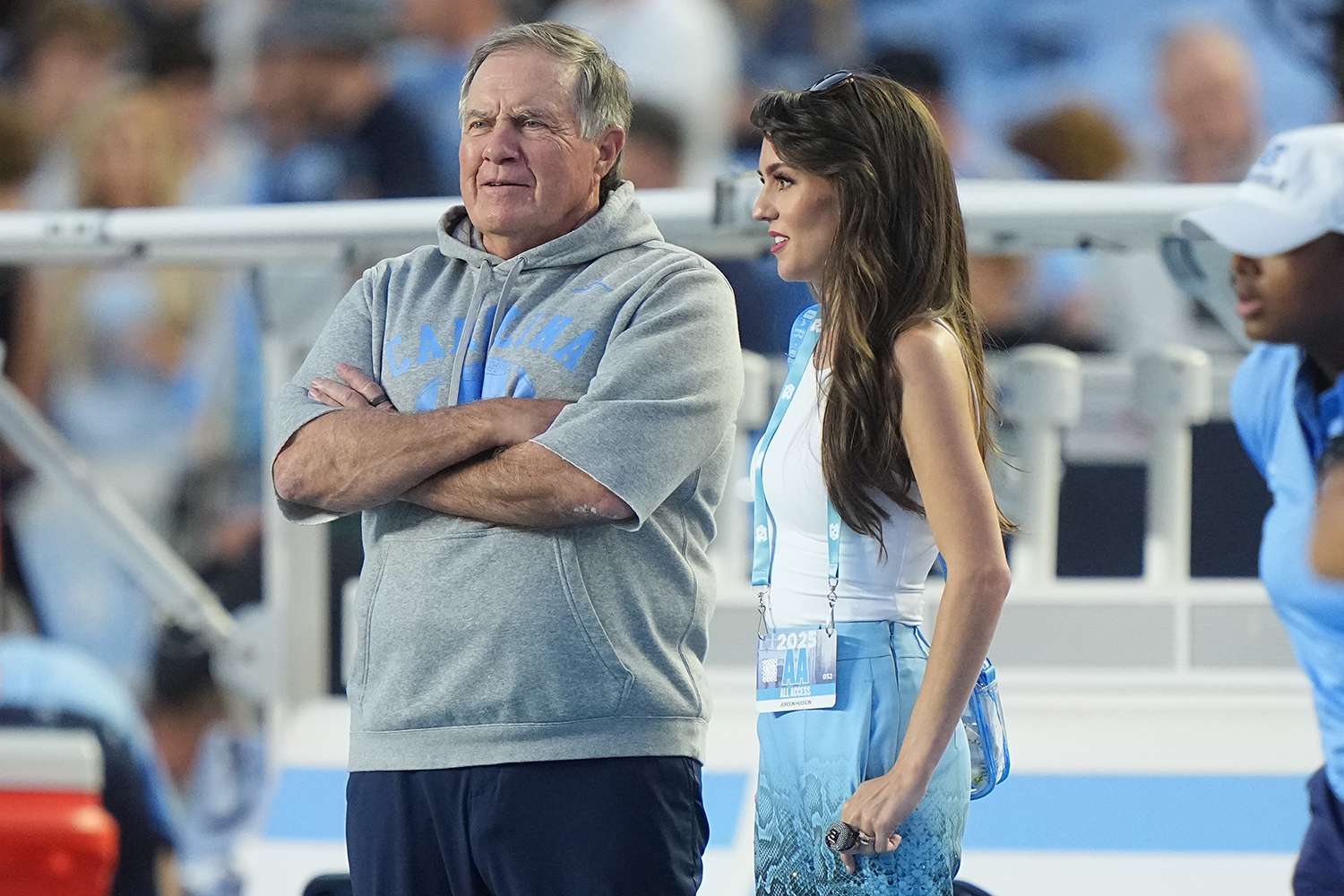 College Football: North Carolina head coach Bill Belichick and girlfriend Jordon Hudson look on from the sideline vs TCU at Kenan Memorial Stadium.