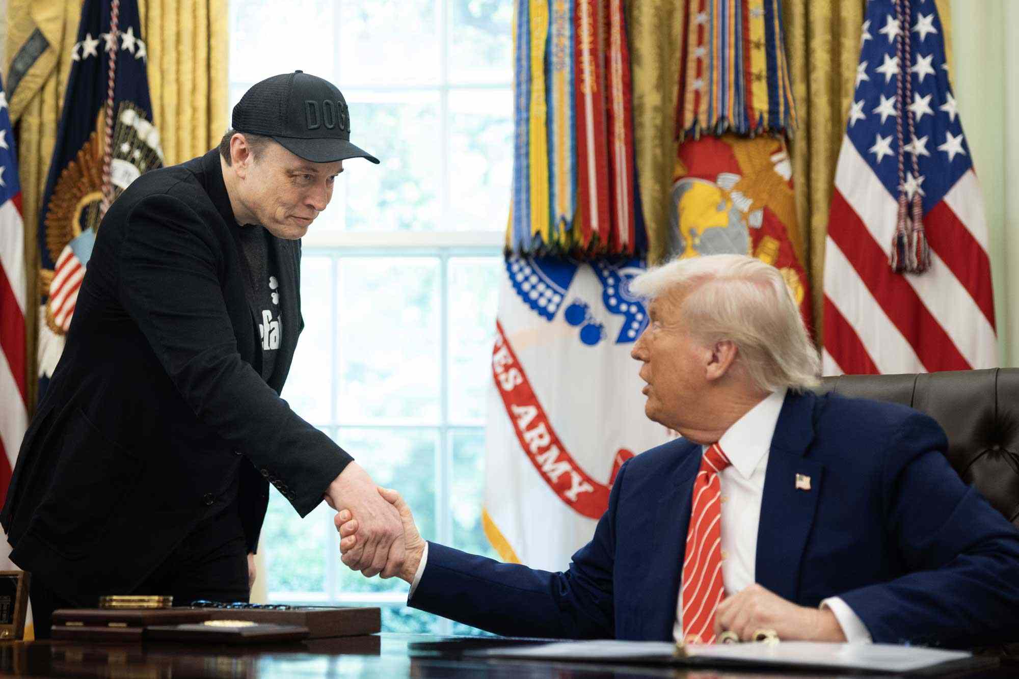 Elon Musk shakes hand of President Trump