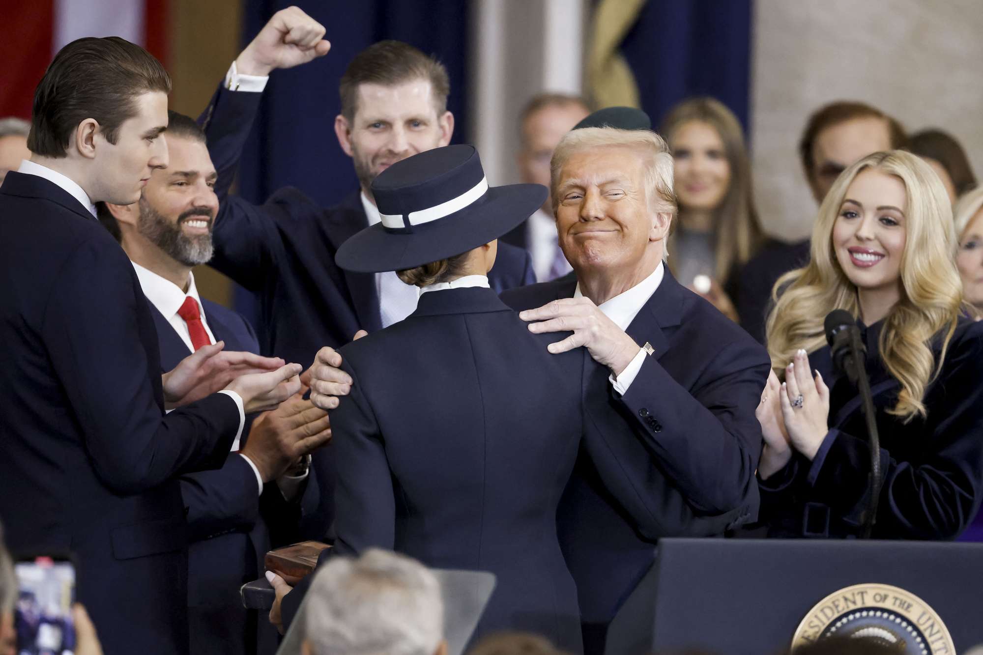 US President Donald Trump greets his family after being sworn in