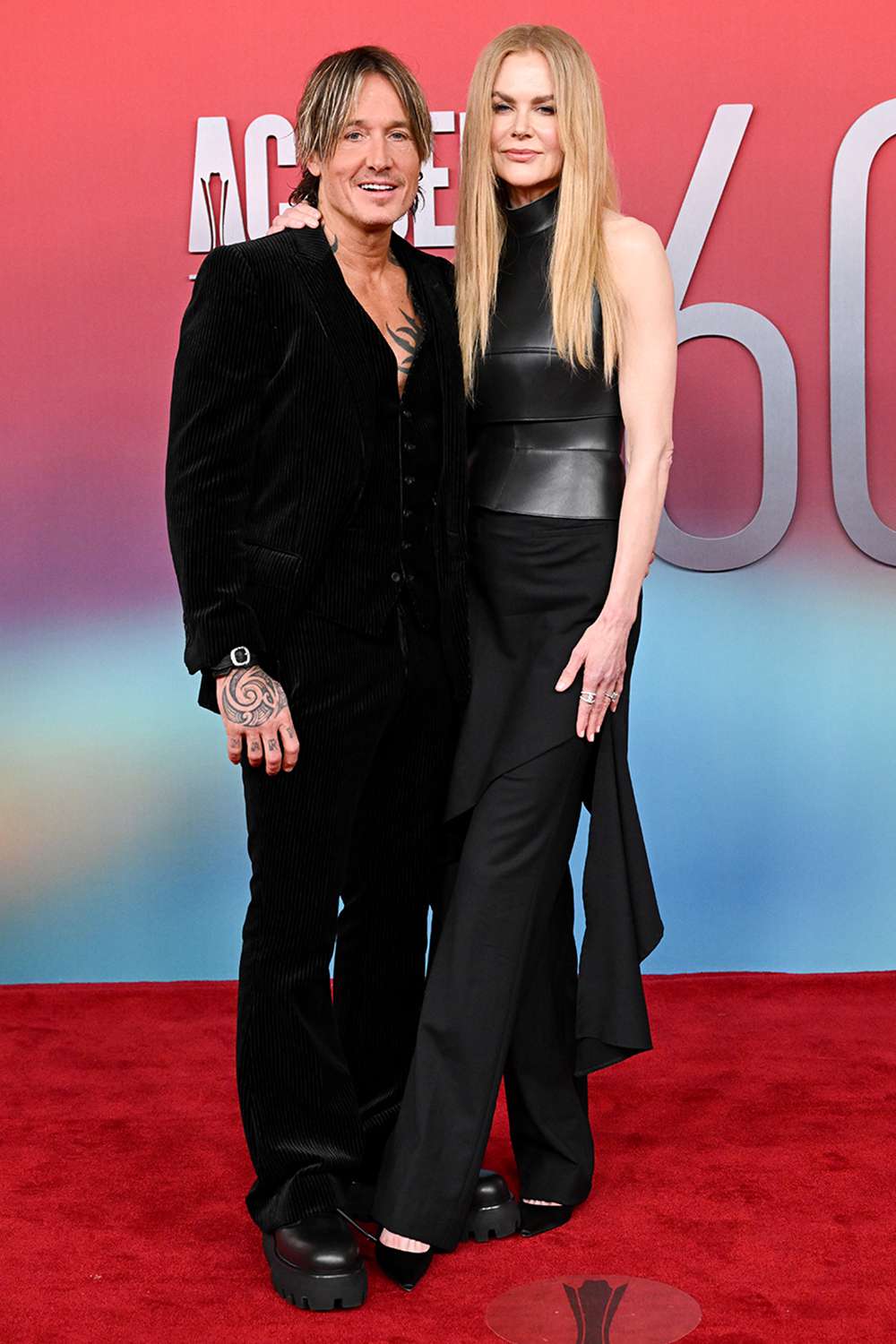 Keith Urban and Nicole Kidman posing together on a red carpet at an event