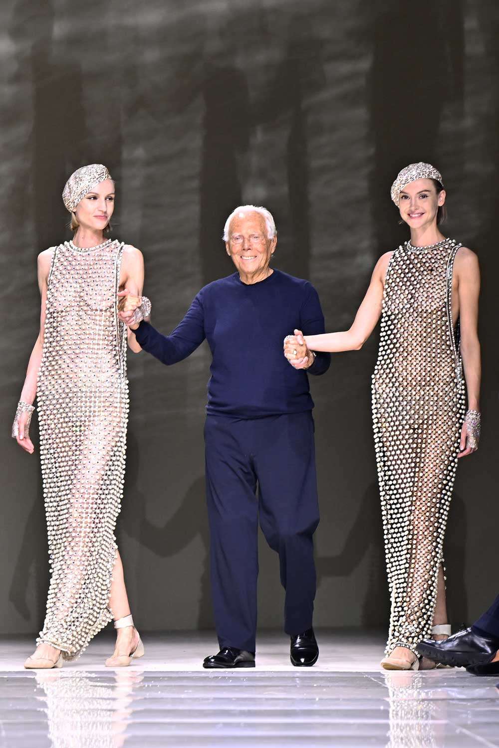 Giorgio Armani with models on runway
