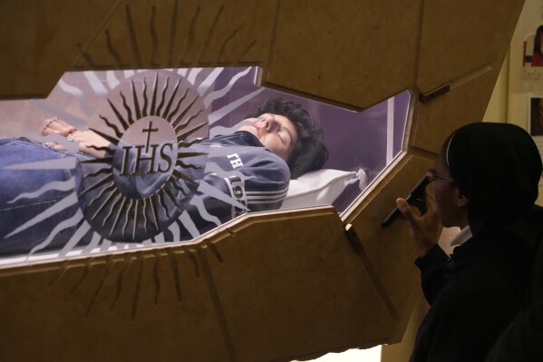 The body of Carlo Acutis, an Italian boy who died in 2006 of leukemia, lies in his tomb in Assisi, Italy, March 1, 2025.
