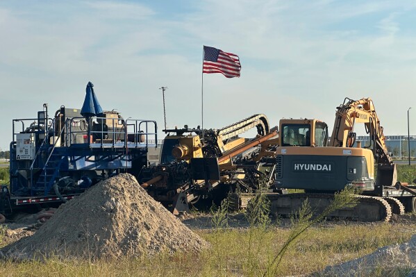 An American flag flies above a piece of heavy machinery at the site of Hyundai Motor Group