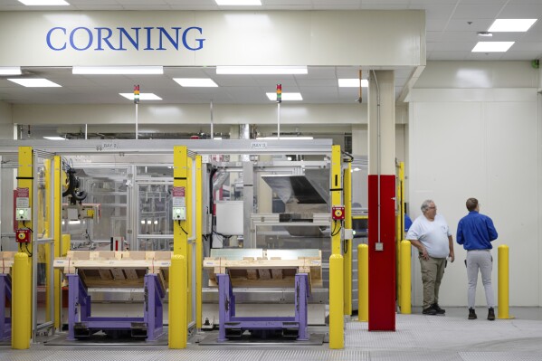 Stacks of glass and employees at Corning