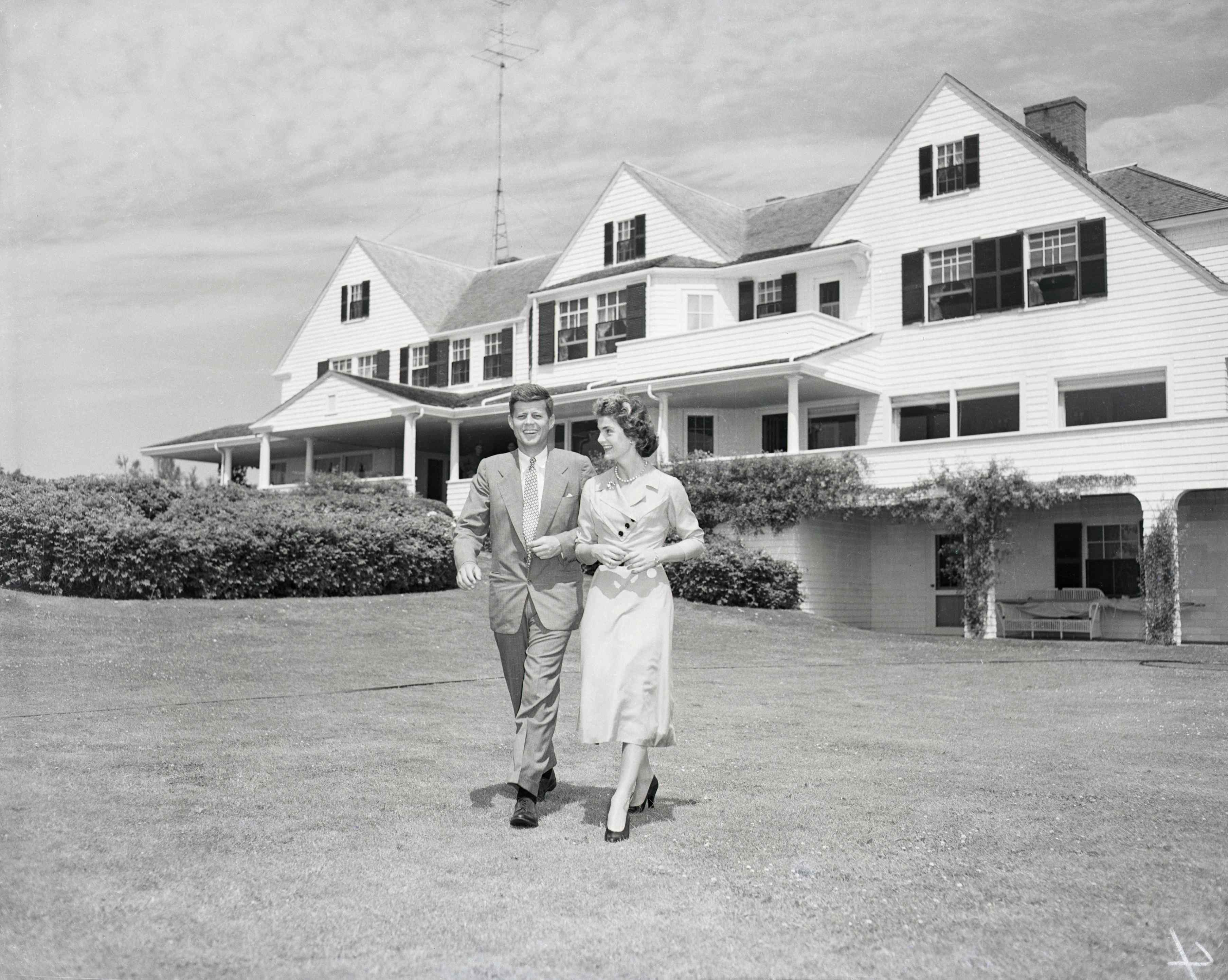 Senator John F. Kennedy and Miss Jacqueline Bouvier stroll across the lawn of his family