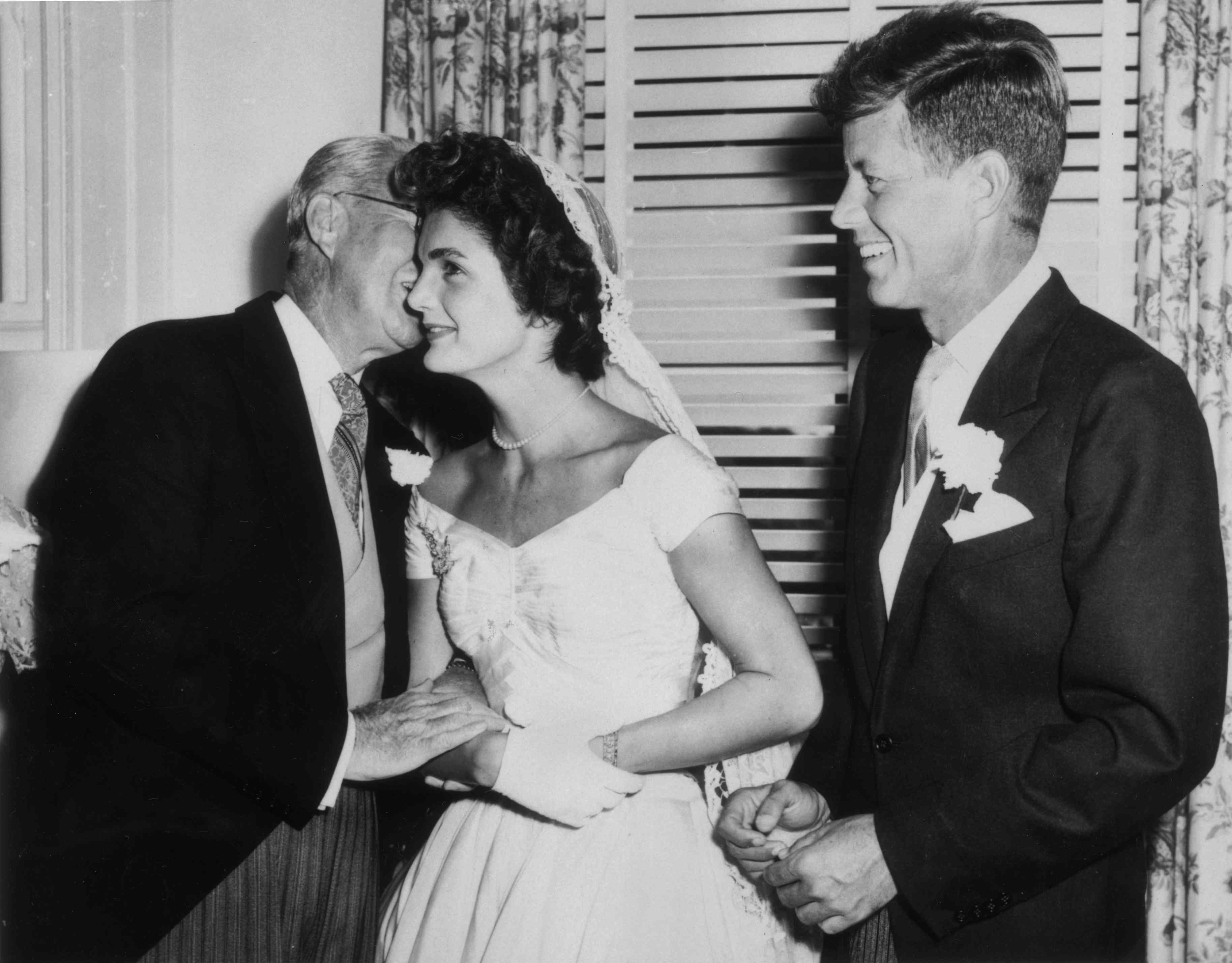 Joseph Kennedy, his new daughter-in-law Jacqueline Bouvier and her new husband John F. Kennedy on their wedding day on September 12, 1953 in Newport, Rhode Island.