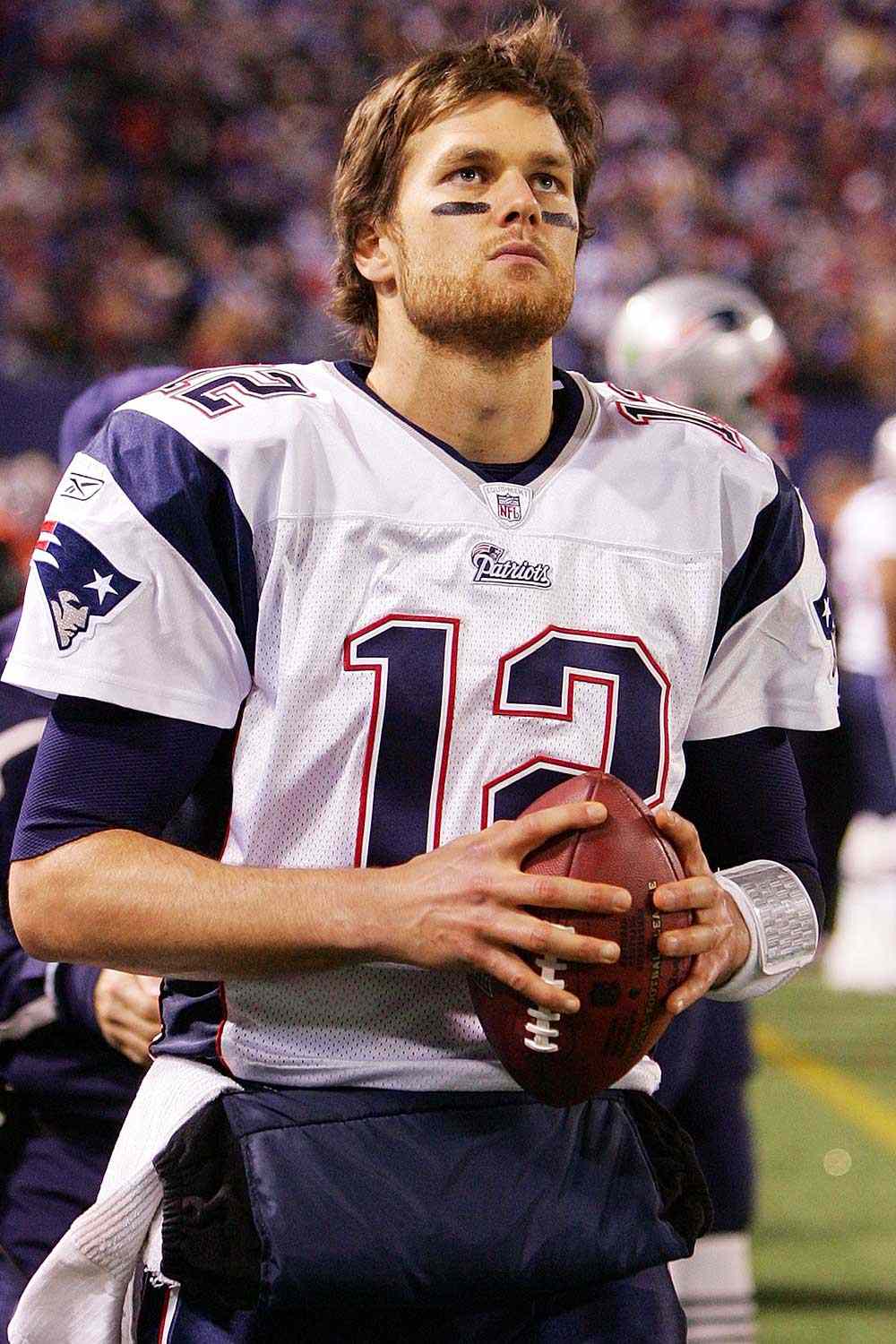 Tom Brady #12 of the New England Patriots looks on from the sidelines against the New York Giants on December 29, 2007 at Giants Stadium in East Rutherford, New Jersey.