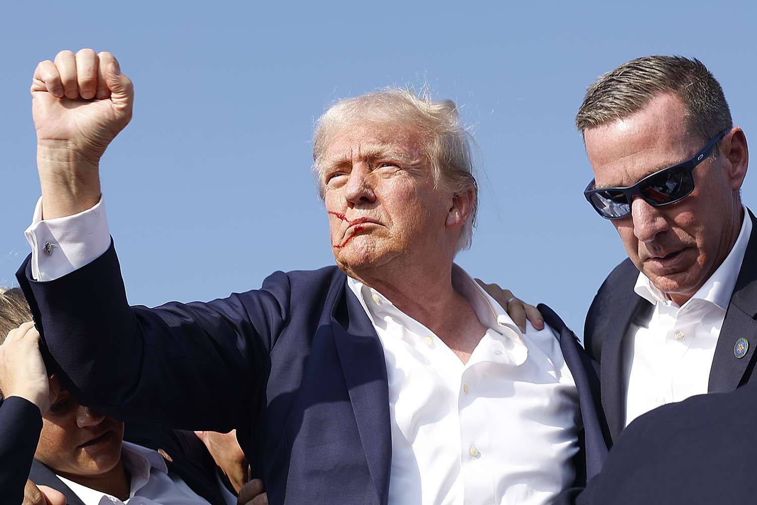Republican presidential candidate former President Donald Trump is rushed offstage by U.S. Secret Service agents after being grazed by a bullet during a rally