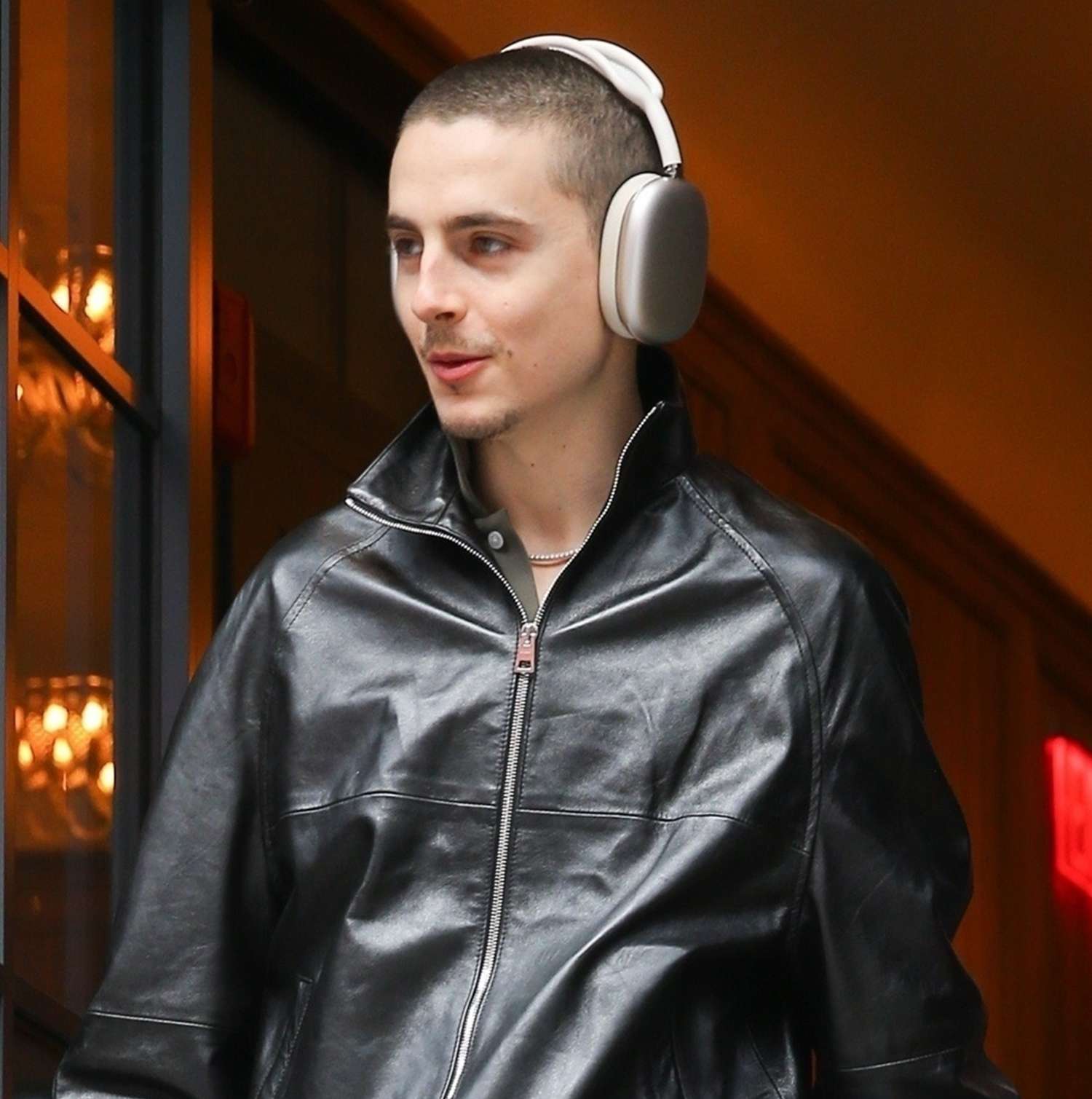Timothée Chalamet looks stylish, listening to music, with coffee in hands while leaving his hotel in New York.