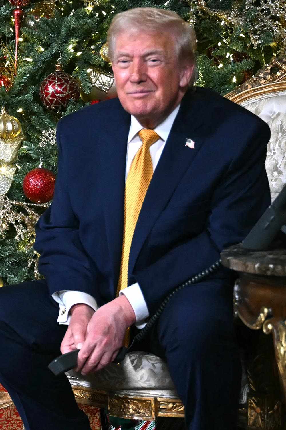 President Donald Trump and first lady Melania Trump participate in NORAD Santa tracker phone calls, on Christmas Eve, from the Mar-a-lago club in Palm Beach, Florida, on December 24, 2025.