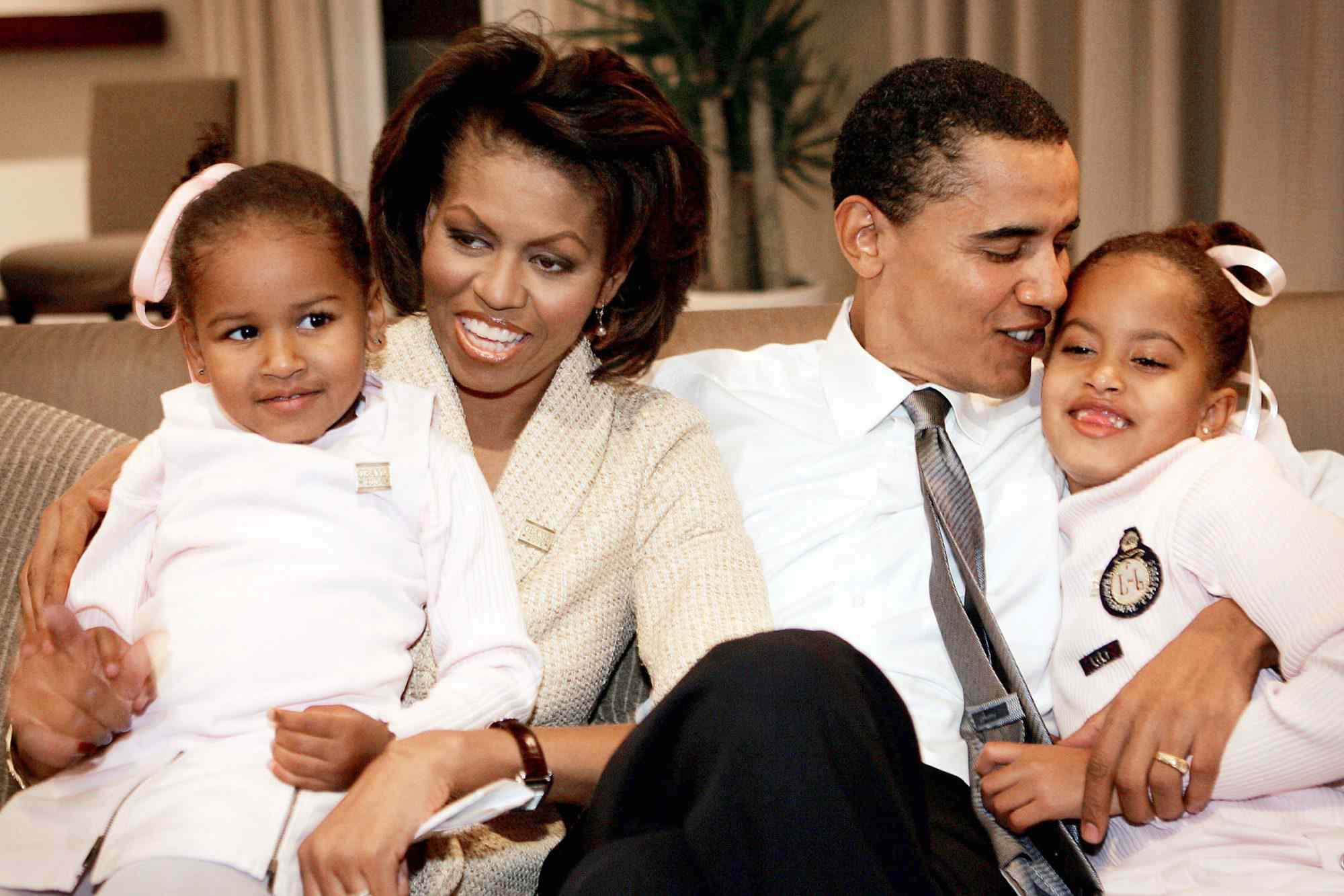 From left to right: Sasha Obama, Michelle Obama, Barack Obama and Malia Obama sit together in a hotel room in Chicago on Nov. 2, 2004