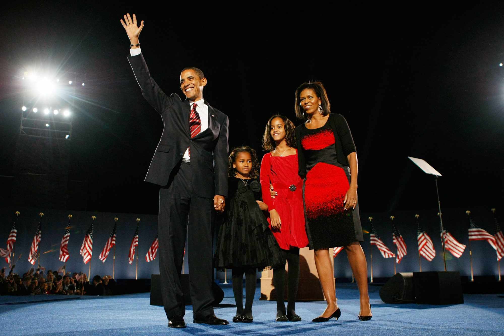 From left: Barack Obama, Sasha Obama, Malia Obama and Michelle Obama stand in front of a crowd at Grant Park in Chicago on Nov. 4, 2008