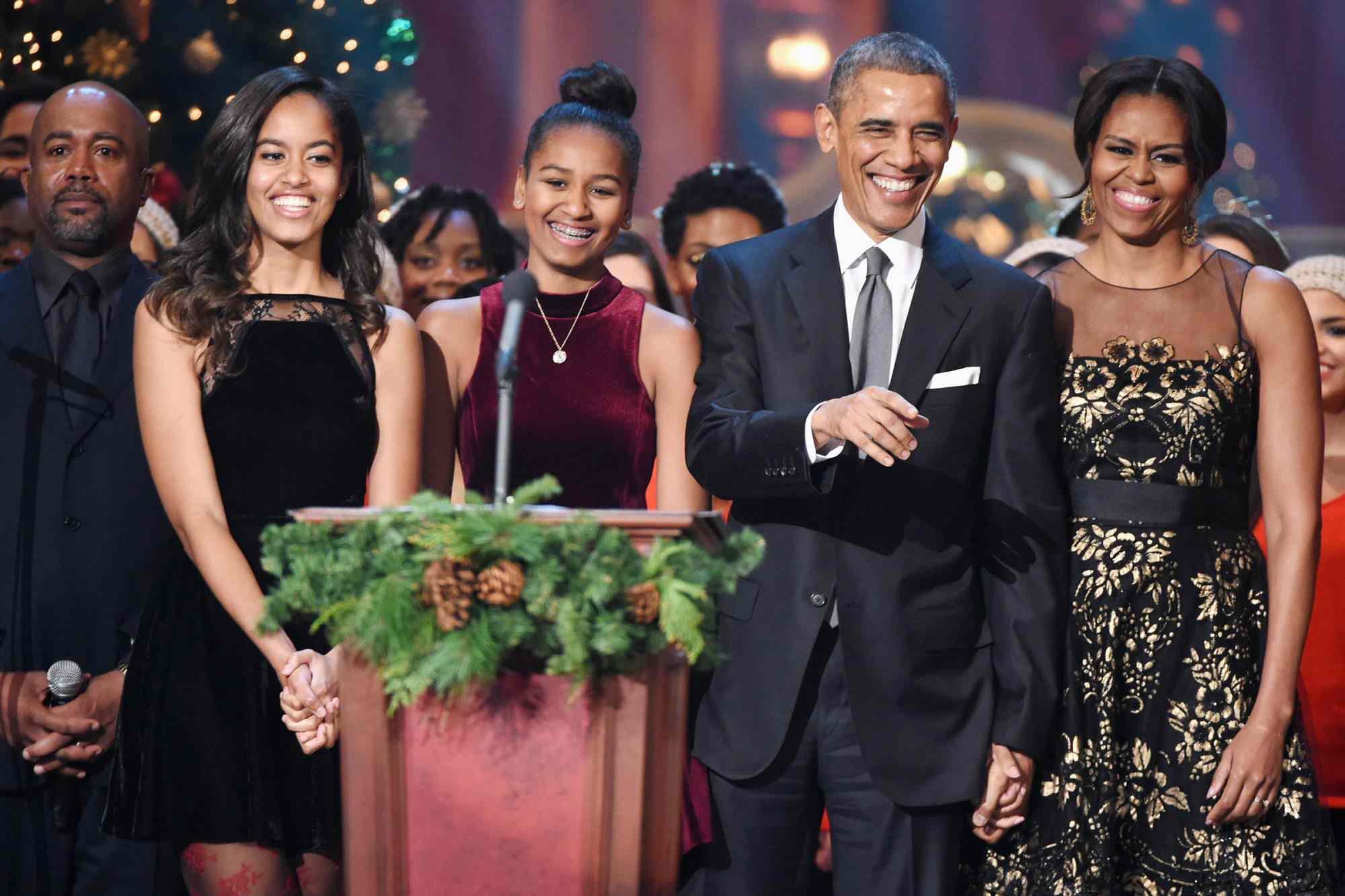 From left to right: Malia Obama, Sasha Obama, Barack Obama and Michelle Obama onstage at the National Building Museum for TNT