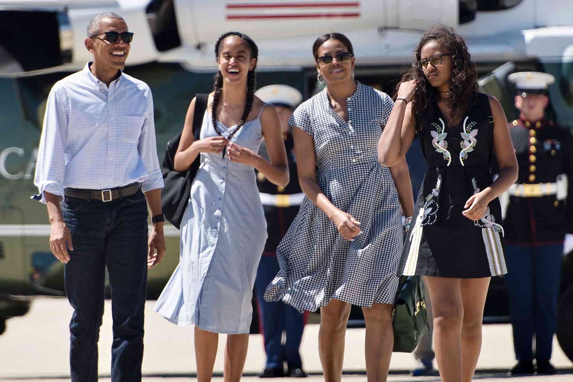 From left to right: Barack Obama, Malia Obama, Michelle Obama and Sasha Obama walk to Air Force One at Castle Airport in Merced County, Calif., on June 19, 2016
