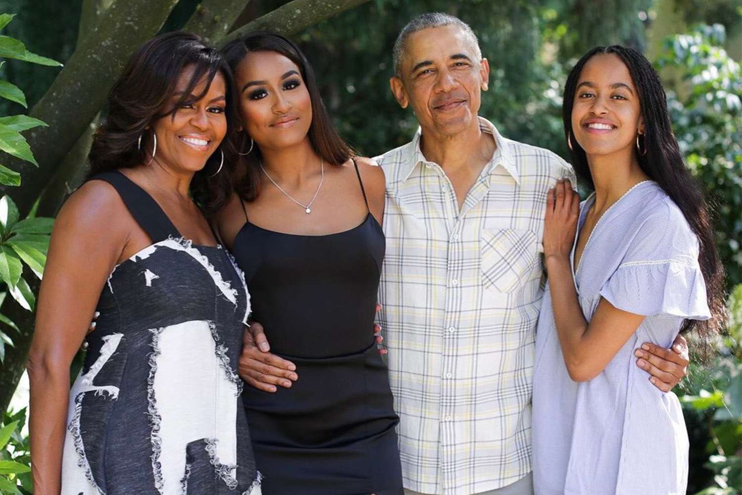 Michelle Obama, Sasha Obama, Barack Obama and Malia Obama smile for an outdoor photo on Thanksgiving in 2019